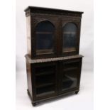 A GOOD 19TH CENTURY ANGLO INDIAN PADAUK WOOD CUPBOARD BOOKCASE, with lancet carved cornice, a pair