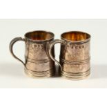 TWO VICTORIAN SILVER MINIATURE TANKARDS. London 1890. 4cms high.