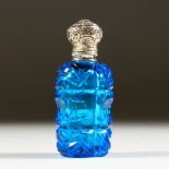 A VICTORIAN BLUE TINTED GLASS SCENT BOTTLE with repousse silver top. 7cms long.
