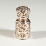 A SMALL VICTORIAN SCENT BOTTLE with floral repousse decoration. Birmingham 1889. Maker C. M. 3.25cms