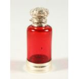 A VICTORIAN PLAIN RUBY GLASS CIRCULAR SCENT BOTTLE AND STOPPER with repousse silver top and plain