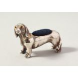 A NOVELTY SILVER DACHSHUND DOG PIN CUSHION. 5cms long.