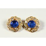 A PAIR OF CHANEL BLUE STONE EAR CLIPS.