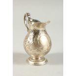 A GEORGE III CREAM JUG with scroll decoration. London 1783.