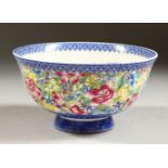 A CHINESE CIRCULAR PORCELAIN BOWL with blue border, the centre and sides with flowers in coloured