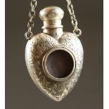 A SMALL VICTORIAN ENGRAVED SILVER HEART SHAPED SCENT BOTTLE AND SCREW OFF TOP on a chain. London