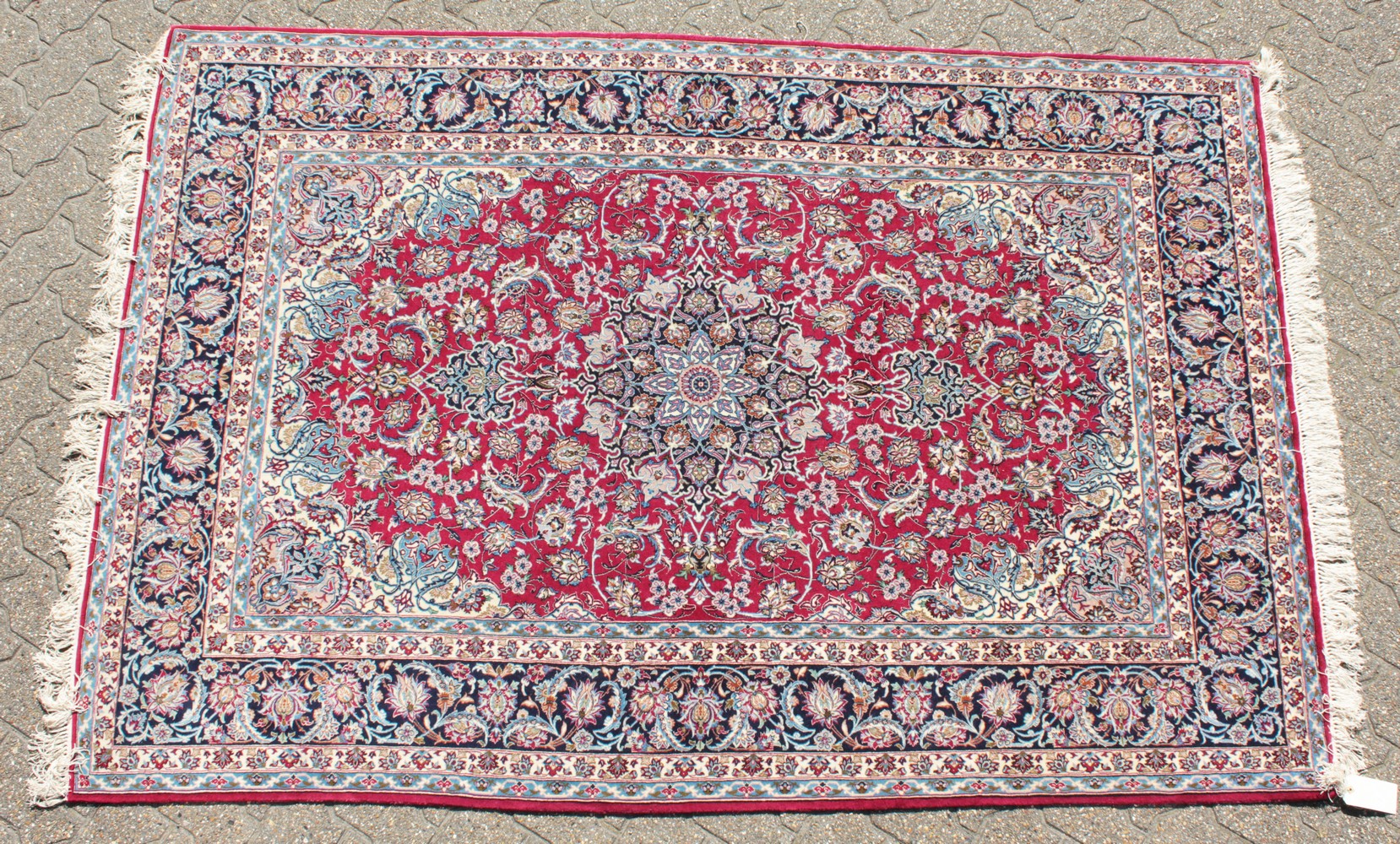 A FINE PERSIAN SILK AND WOOL ISFAHAN CARPET with allover red and blue design.