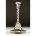 A RARE EARLY 18TH CENTURY GLASS WIG STAND with white opaque glass stem and large circular base.