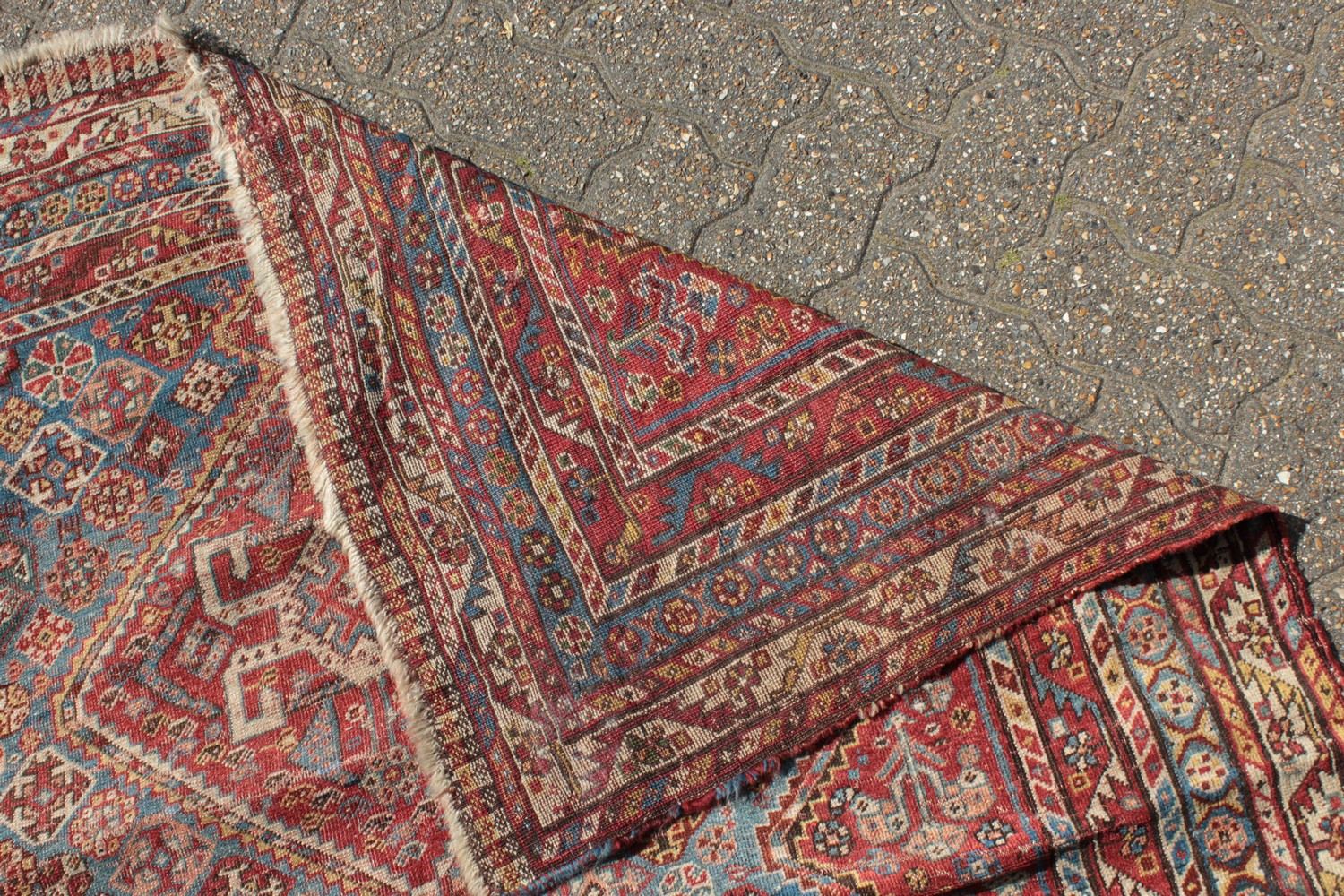 A LARGE OLD PERSIAN SHIRAZ RUG with three main diamond shaped motifs. 7ft 4ins x 4ft 8ins. - Image 9 of 10