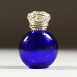 A SMALL BRISTOL BLUE SCENT BOTTLE with repousse silver top and plain glass stopper. 5cms long x 3.