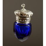 A SMALL BRISTOL BLUE GLASS FACET CUT SCENT BOTTLE with silver top. 4cms long.