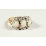 A 9CT GOLD THREE STONE OPAL AND DIAMOND RING, boxed.