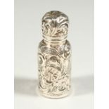 A SMALL VICTORIAN SILVER CASED SCENT BOTTLE AND STOPPER with repousse decoration. Birmingham 1876.