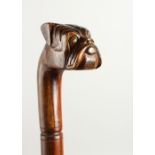 A 20TH CENTURY WALKING STICK, the handle carved as a bulldog. 92cms long.