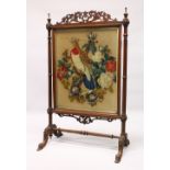 A VICTORIAN MAHOGANY FRAMED FIRESCREEN, with beadwork and woolwork panel depicting a bird on a