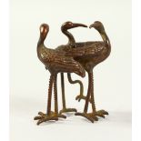 A JAPANESE BRONZE OF A GROUP OF THREE FLAMINGOS. 2ins high.