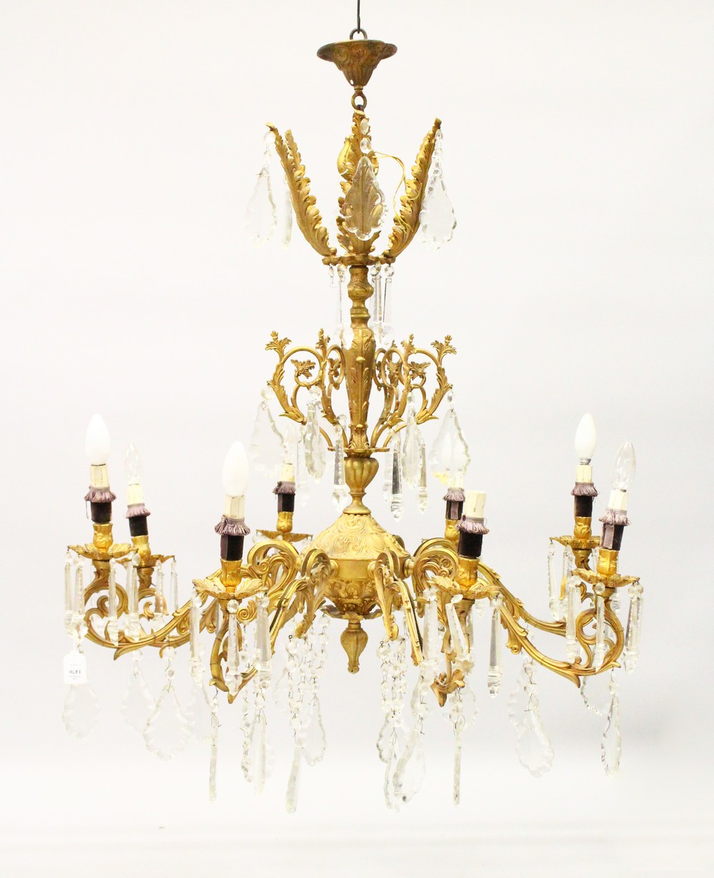 A LARGE LOUIS XVITH DESIGN GILT METAL EIGHT BRANCH CHANDELIER with over 200 cut crystal drops.