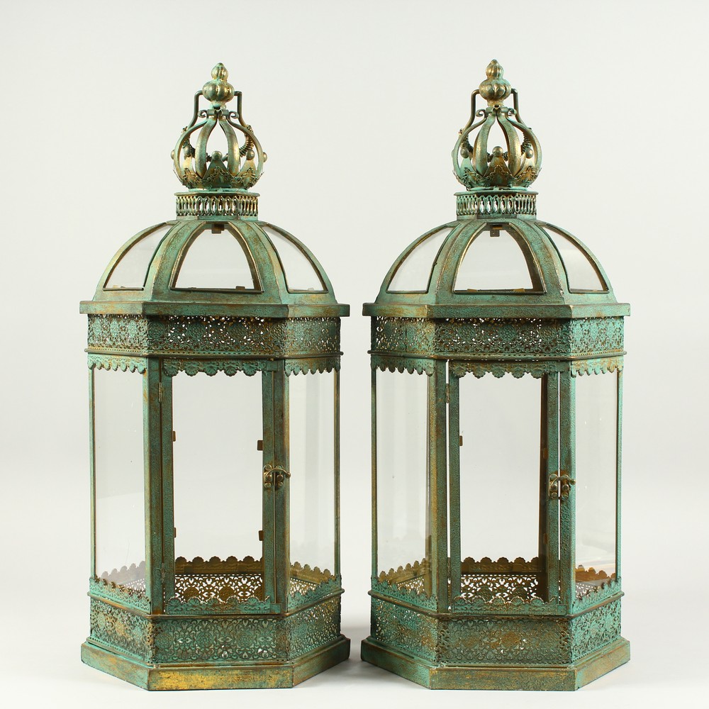 A PAIR OF GILDED METAL HEXAGONAL LANTERNS with glass sides and doors. 2ft 1in high.