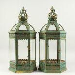 A PAIR OF GILDED METAL HEXAGONAL LANTERNS with glass sides and doors. 2ft 1in high.