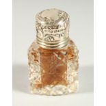 AN EDWARD VII CUT GLASS TRIANGULAR SHAPED SCENT BOTTLE with silver top and plain glass stopper.
