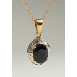 A 9CT GOLD OVAL SAPPHIRE AND DIAMOND NECKLACE on a chain, BOXED.