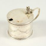 A VICTORIAN ENGRAVED CIRCULAR MUSTARD POT AND COVER with sapphire blue liner. London 1867. Maker