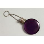 A VICTORIAN AMETHYST GLASS CIRCULAR SCENT BOTTLE with silver top and chain. 4cms diameter.