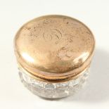 A GEORGE V CUT GLASS PIN BOX with silver top initialled D. Birmingham 1914. 4.5cms diameter.