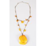 A GOOD LARGE AMBER PENDANT NECKLACE, 58 grams.
