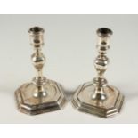 A VERY GOOD MATCH PAIR OF GEORGE II AND GEORGE II CAST SILVER CANDLESTICKS, 5.75ins high on