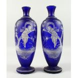 A VERY GOOD PAIR OF MARY GREGORY RICH DARK BLUE VASES. Mirror images of a young girl on a branch.