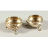 TWO GEORGE III CIRCULAR SALTS, each on three pad feet. London 1782 & 1789.