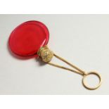 A VICTORIAN RUBY GLASS CIRCULAR SCENT BOTTLE with screw off silver gilt cap and chain. 4.5cms