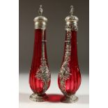 A VERY GOOD PAIR OF 19TH CENTURY CONTINENTAL RUBY GLASS SILVER MOUNTED SCENT BOTTLES, the silver
