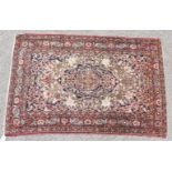 A GOOD PERSIAN ISFAHAN NAJAFABAD RUG with central motif and floral border. 6ft 10ins x 4ft 6ins.