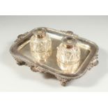 AN OLD SHEFFIELD PLATE TWO BOTTLE INKSTAND with gadrooned edge, shell mounts on claw feet. 11ins