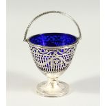 A GOOD GEORGE III PIERCED PEDESTAL SUGAR BASKET engraved with urns and swags, bead decoration, swing