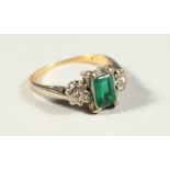 AN 18CT GOLD, DIAMOND AND EMERALD THREE STONE RING.
