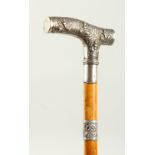 A WALKING STICK with Burmese silver handle. London 1908. 2ft long.