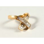 A 14CT GOLD AND DIAMOND CROSSOVER RING.