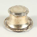 AN EDWARD VII CIRCULAR CAPSTAN PATTERN INKSTAND with engraved lid. London 1901. 4.25ins diameter.