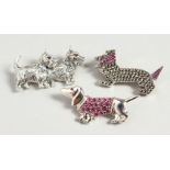 THREE SILVER GEM SET "DOG" BROOCHES.