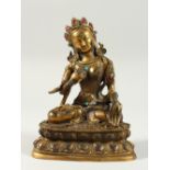 A CHINESE BRONZE GOD sitting cross legged, with turquoise stones. 6.5ins high.