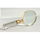 A MAGNIFYING GLASS with cut glass handle.