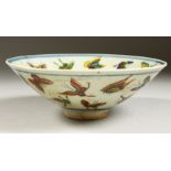 A CHINESE CIRCULAR PORCELAIN BOWL decorated with butterflies. 6.5ins diameter.