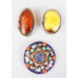 AN ENAMEL TORTOISESHELL AND CORAL BROOCH and two other brooches.