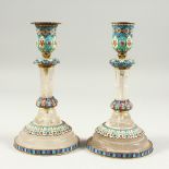 A VERY GOOD PAIR OF RUSSIAN CRYSTAL AND CHAMPLEVE ENAMEL CANDLESTICKS on circular bases. 9cms high.