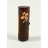 A SMALL GLASS SCENT BOTTLE AND STOPPER in a folding tortoiseshell case. 5.5cms long.