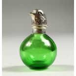 A GREEN NOVELTY SCENT BOTTLE with silver top as a bird's head. 6cms high.