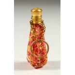 A LOVELY RUBY GLASS GILT DECORATED SCENT BOTTLE with gilt cap and stopper on chain. 6.5cms long.